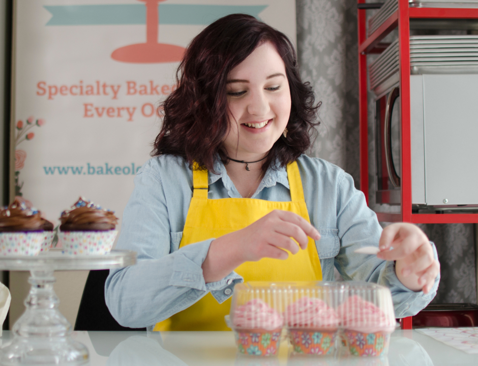 Happy girl doing cupcakes