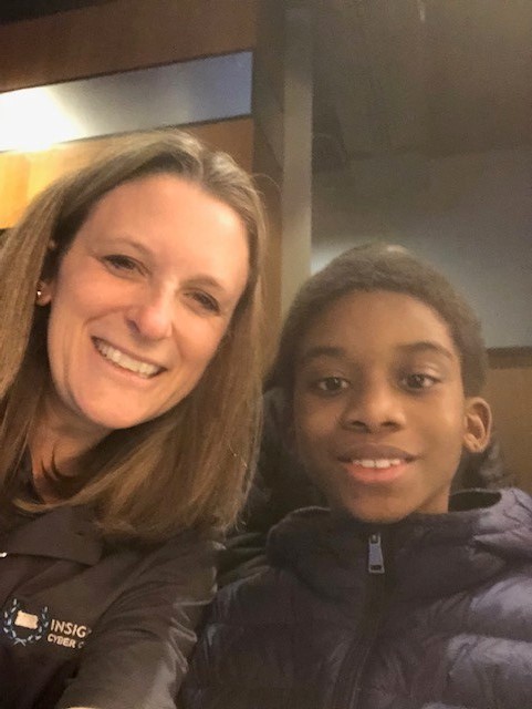 Teacher and elementary school student smiling