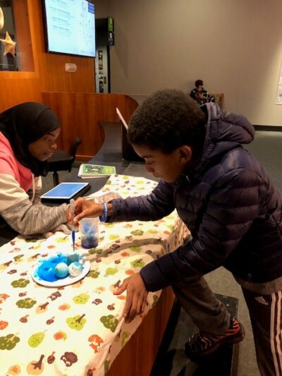 Elementary school student painting at the National science academy