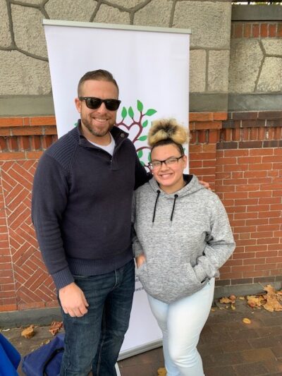 Two people smiling at the camera