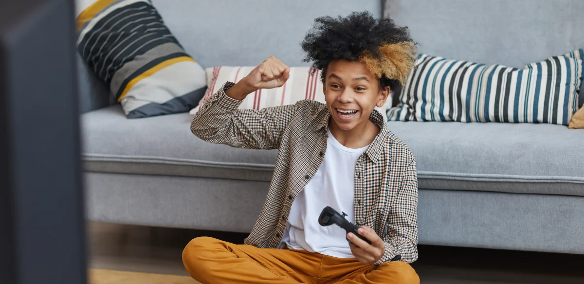 Boy playing video games at home