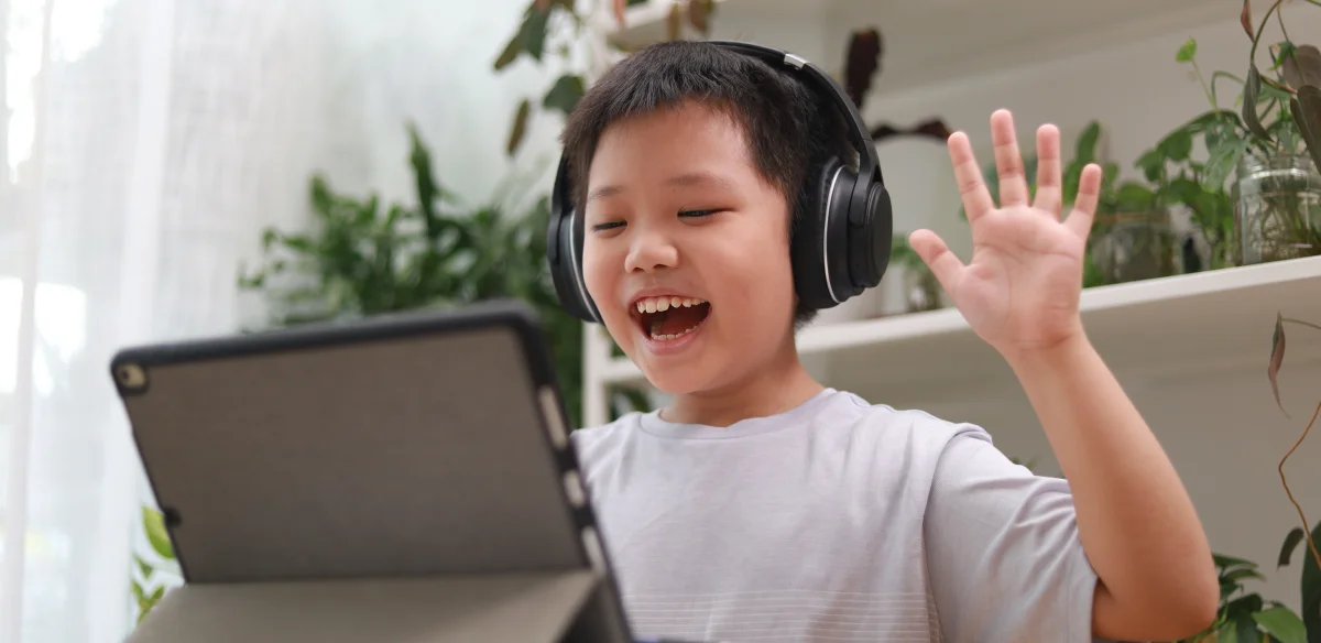 Little boy attending to an online class